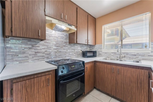 1470 Elizabeth Ave Unit 1, Las Vegas, NV 89119 - kitchen featuring black appliances, under cabinet range hood, a sink, and light countertops