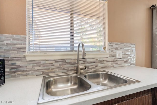 1470 Elizabeth Ave Unit 1, Las Vegas, NV 89119 - kitchen view of a sink, tasteful backsplash, and light countertops