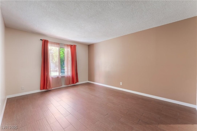 1470 Elizabeth Ave Unit 1, Las Vegas, NV 89119 - empty room featuring a textured ceiling, wood finished floors, and baseboards