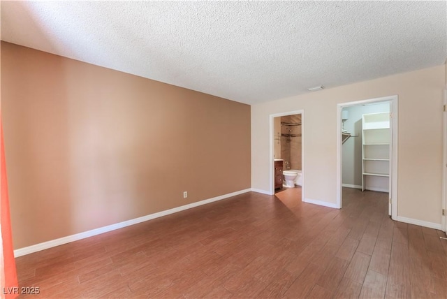 1470 Elizabeth Ave Unit 1, Las Vegas, NV 89119 - unfurnished room featuring wood finished floors, baseboards, and a textured ceiling