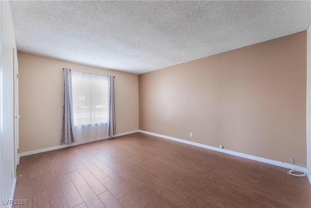 1470 Elizabeth Ave Unit 1, Las Vegas, NV 89119 - empty room featuring dark wood-style flooring, baseboards, and a textured ceiling