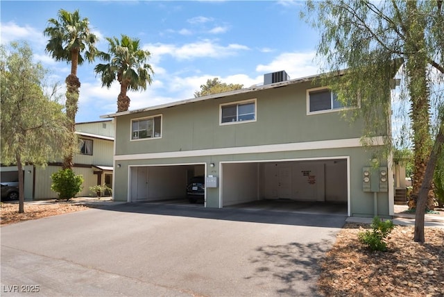 1470 Elizabeth Ave Unit 1, Las Vegas, NV 89119 - traditional-style house featuring asphalt driveway, central AC unit, and an attached garage