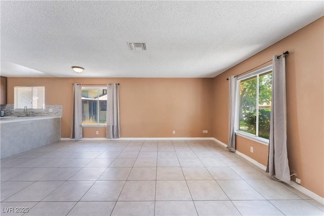 1470 Elizabeth Ave Unit 1, Las Vegas, NV 89119 - spare room with a textured ceiling and light tile patterned floors