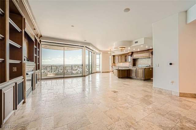 9101 Alta Dr Unit 1203, Las Vegas, NV 89145 - unfurnished living room featuring stone tile flooring, baseboards, expansive windows, recessed lighting, and a sink