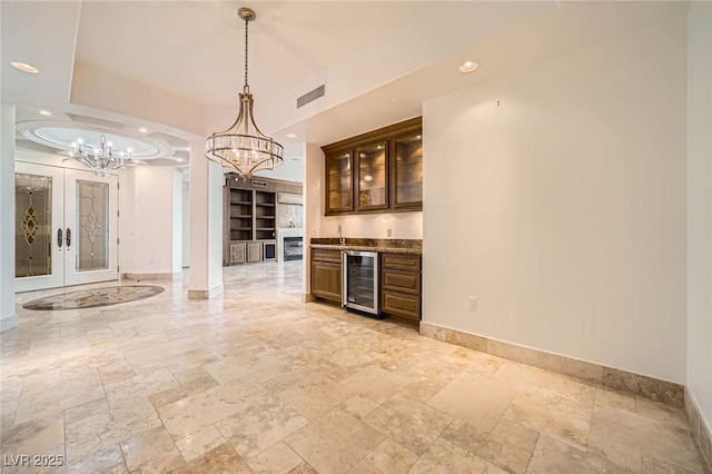 9101 Alta Dr Unit 1203, Las Vegas, NV 89145 - indoor dry bar featuring beverage cooler, a chandelier, baseboards, stone tile flooring, and recessed lighting
