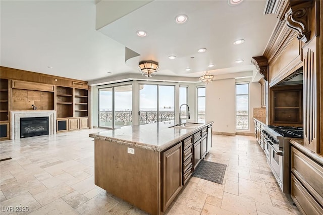 9101 Alta Dr Unit 1203, Las Vegas, NV 89145 - kitchen with stone tile flooring, a sink, recessed lighting, range with two ovens, and light stone countertops