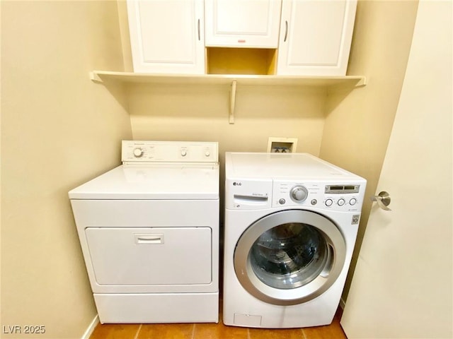 3372 Wayward Ct, Las Vegas, NV 89129 - laundry room featuring washing machine and dryer, cabinet space, light tile patterned floors, and baseboards