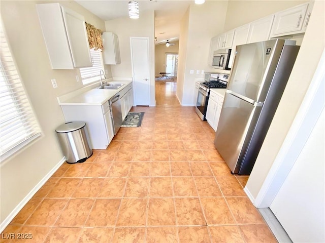 3372 Wayward Ct, Las Vegas, NV 89129 - kitchen featuring stainless steel appliances, a sink, healthy amount of natural light, and light countertops