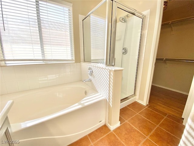 3372 Wayward Ct, Las Vegas, NV 89129 - full bathroom with a garden tub, a stall shower, a walk in closet, and tile patterned floors