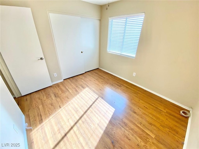3372 Wayward Ct, Las Vegas, NV 89129 - unfurnished bedroom with wood finished floors, baseboards, and a closet