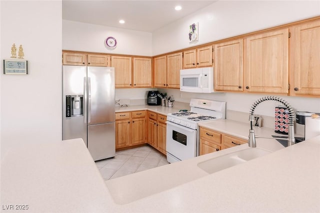 4970 Black Bear Rd Unit 101, Las Vegas, NV 89149 - kitchen with white appliances, light brown cabinets, light countertops, a sink, and recessed lighting