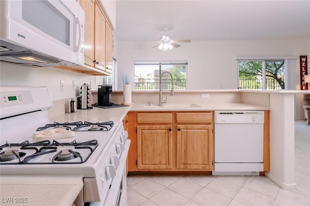 4970 Black Bear Rd Unit 101, Las Vegas, NV 89149 - kitchen with white appliances, a sink, light countertops, light brown cabinets, and a ceiling fan