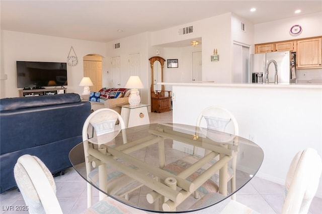 4970 Black Bear Rd Unit 101, Las Vegas, NV 89149 - dining room featuring light tile patterned floors, arched walkways, and recessed lighting