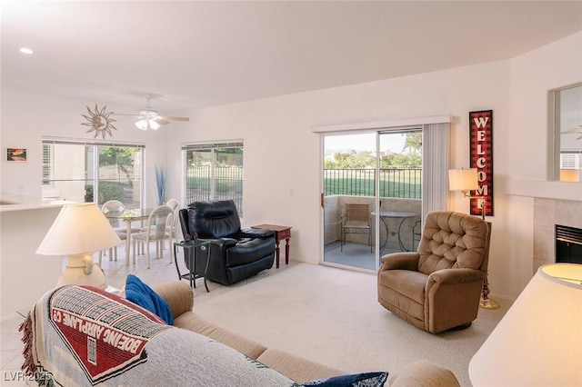 4970 Black Bear Rd Unit 101, Las Vegas, NV 89149 - living area with healthy amount of natural light, ceiling fan, a tile fireplace, and carpet flooring