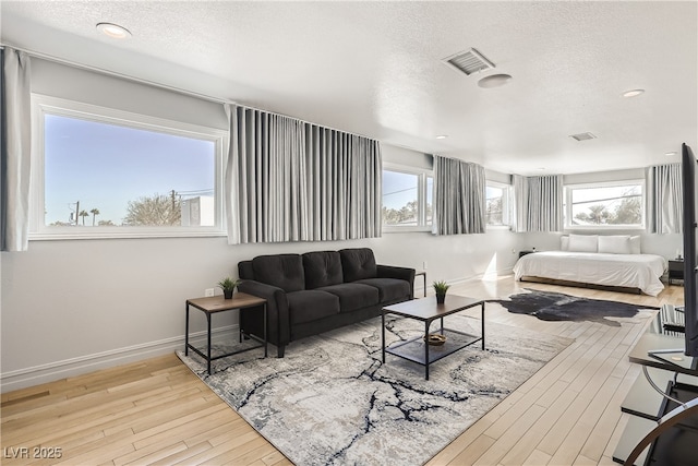 2890 Belcastro St, Las Vegas, NV 89117 - bedroom with a textured ceiling, hardwood / wood-style floors, multiple windows, baseboards, and recessed lighting