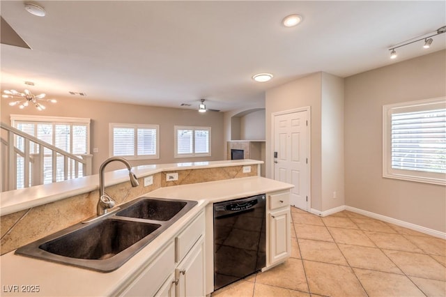 8775 Traveling Breeze Ave Unit 102, Las Vegas, NV 89178 - kitchen with dishwasher, a sink, light tile patterned flooring, white cabinetry, and baseboards