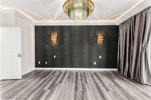 2407 Ridgeline Wash St, Las Vegas, NV 89138 - spare room with wood finished floors, a chandelier, and baseboards