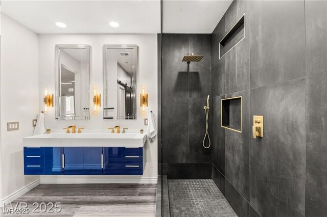 2407 Ridgeline Wash St, Las Vegas, NV 89138 - full bathroom featuring wood finished floors, double vanity, tiled shower, baseboards, and recessed lighting
