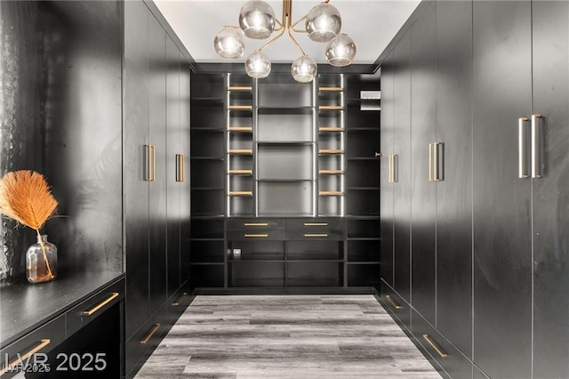 2407 Ridgeline Wash St, Las Vegas, NV 89138 - walk in closet with wood finished floors and a chandelier