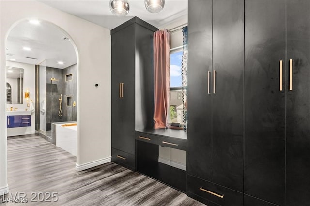 2407 Ridgeline Wash St, Las Vegas, NV 89138 - foyer entrance with arched walkways, wood finished floors, and baseboards