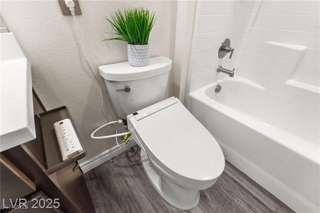 2407 Ridgeline Wash St, Las Vegas, NV 89138 - bathroom featuring toilet, wood finished floors, baseboards, a textured wall, and shower / bathtub combination