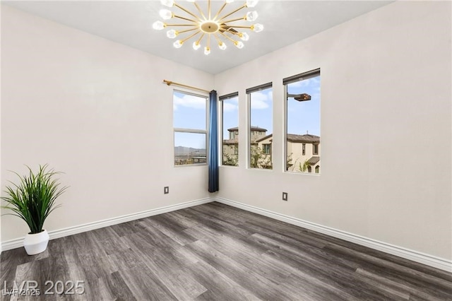 2407 Ridgeline Wash St, Las Vegas, NV 89138 - unfurnished room featuring a chandelier, dark wood-style flooring, and baseboards