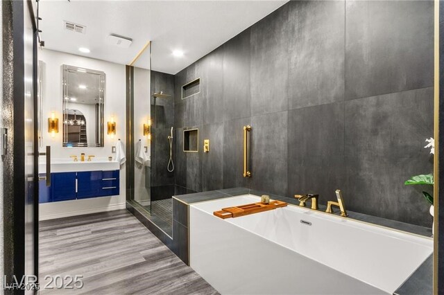 2407 Ridgeline Wash St, Las Vegas, NV 89138 - bathroom featuring a soaking tub, a shower stall, wood finished floors, and vanity