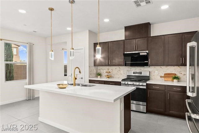 2407 Ridgeline Wash St, Las Vegas, NV 89138 - kitchen with stainless steel appliances, a sink, light tile patterned flooring, decorative backsplash, and dark brown cabinetry