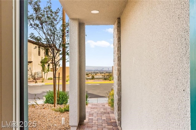 2407 Ridgeline Wash St, Las Vegas, NV 89138 - doorway to outside featuring a textured wall and expansive windows