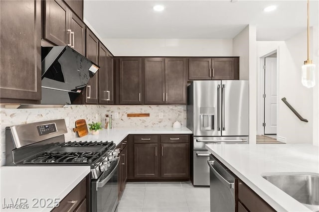 2407 Ridgeline Wash St, Las Vegas, NV 89138 - kitchen featuring stainless steel appliances, dark brown cabinetry, extractor fan, tasteful backsplash, and recessed lighting
