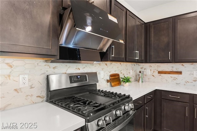 2407 Ridgeline Wash St, Las Vegas, NV 89138 - kitchen with stainless steel range with gas stovetop, extractor fan, dark brown cabinetry, tasteful backsplash, and light countertops