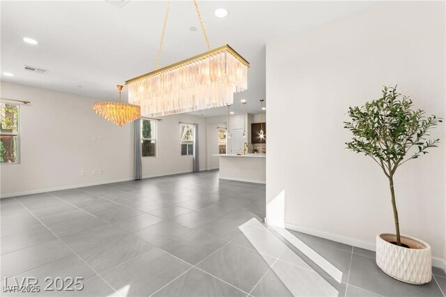 2407 Ridgeline Wash St, Las Vegas, NV 89138 - unfurnished living room featuring a chandelier, recessed lighting, tile patterned floors, and baseboards