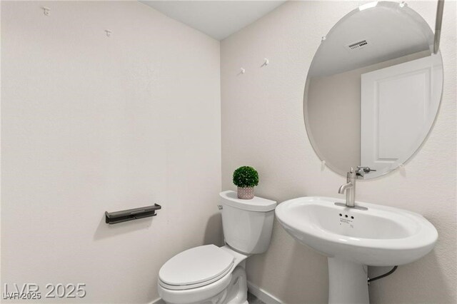 2407 Ridgeline Wash St, Las Vegas, NV 89138 - half bathroom featuring toilet and baseboards