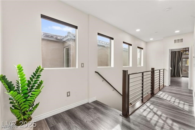 2407 Ridgeline Wash St, Las Vegas, NV 89138 - hallway featuring healthy amount of natural light, wood finished floors, an upstairs landing, baseboards, and recessed lighting