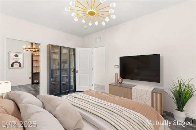 2407 Ridgeline Wash St, Las Vegas, NV 89138 - bedroom featuring a chandelier, wood finished floors, and baseboards