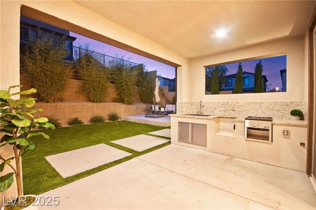 2407 Ridgeline Wash St, Las Vegas, NV 89138 - patio terrace at dusk featuring a sink, a fenced backyard, area for grilling, and a patio area
