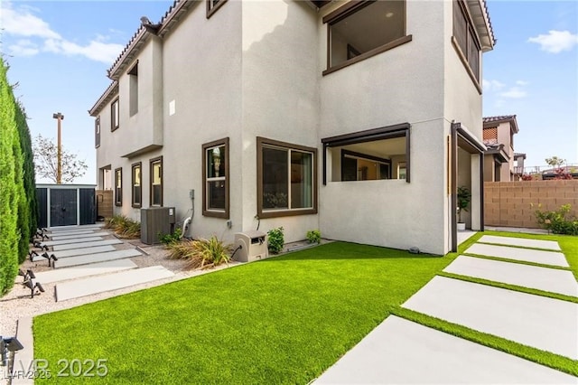 2407 Ridgeline Wash St, Las Vegas, NV 89138 - back of property featuring stucco siding, central AC unit, and a patio