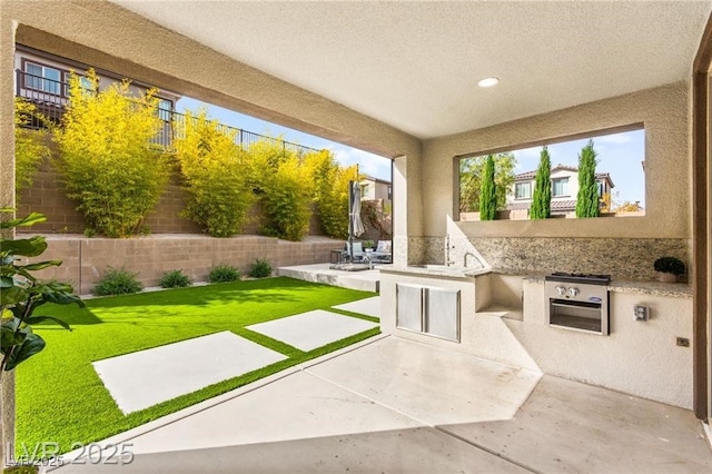 2407 Ridgeline Wash St, Las Vegas, NV 89138 - view of patio with an outdoor kitchen