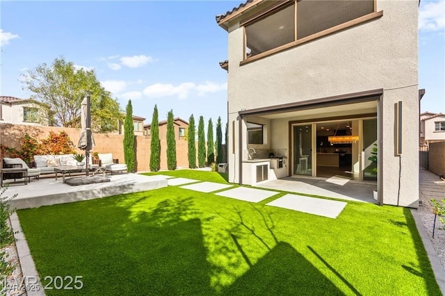 2407 Ridgeline Wash St, Las Vegas, NV 89138 - back of house featuring exterior kitchen, outdoor lounge area, a patio, stucco siding, and a sink