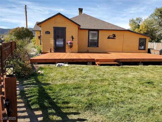 2228 Campton, Ely, NV 89301 - back of property featuring a shingled roof, a chimney, and a deck