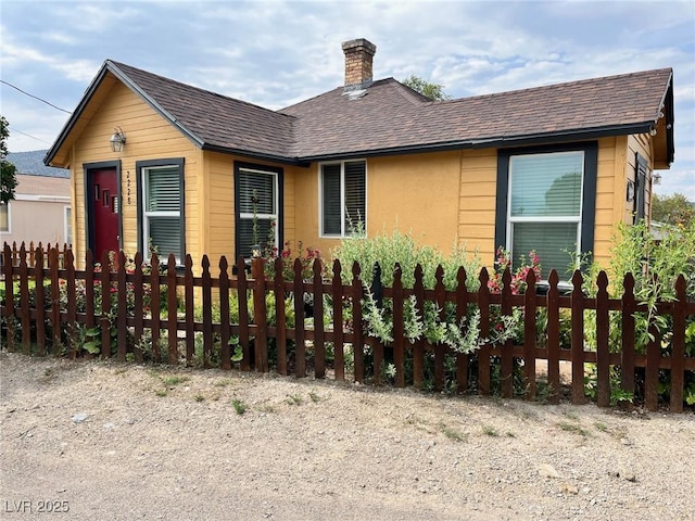 2228 Campton, Ely, NV 89301 - view of front of property with a fenced front yard, a chimney, and roof with shingles