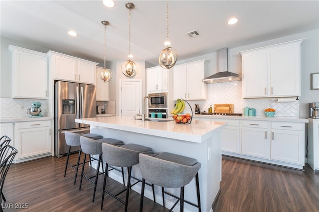 10829 Crestview Pointe Ave, Las Vegas, NV 89166 - kitchen featuring stainless steel appliances, wall chimney range hood, backsplash, a kitchen bar, and white cabinetry