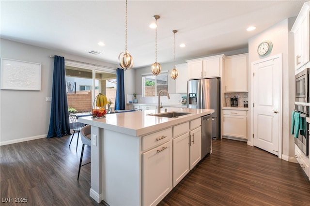 10829 Crestview Pointe Ave, Las Vegas, NV 89166 - kitchen with a sink, appliances with stainless steel finishes, backsplash, dark wood-style floors, and light countertops