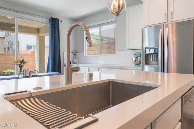 10829 Crestview Pointe Ave, Las Vegas, NV 89166 - kitchen with appliances with stainless steel finishes, light countertops, backsplash, white cabinets, and a sink