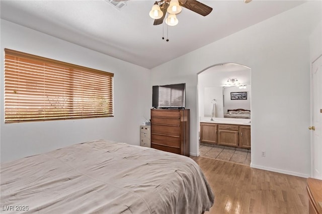 2037 Merano Ct, Las Vegas, NV 89123 - bedroom featuring lofted ceiling, arched walkways, light wood-style flooring, ensuite bathroom, and a ceiling fan
