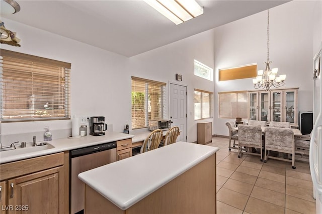 2037 Merano Ct, Las Vegas, NV 89123 - kitchen with stainless steel dishwasher, a chandelier, light tile patterned flooring, a center island, and light countertops