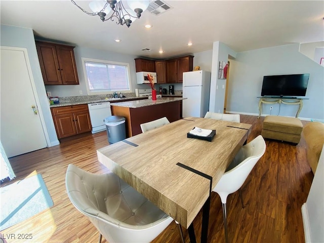 11117 Okeefe Ct, Las Vegas, NV 89144 - dining space featuring a chandelier, light wood-style floors, recessed lighting, and baseboards
