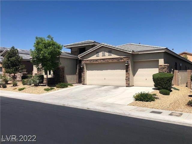 7934 Cape Flattery Ave, Las Vegas, NV 89147 - view of front of house featuring an attached garage, stucco siding, driveway, and stone siding