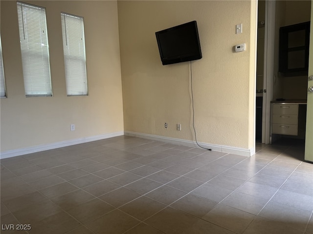 7934 Cape Flattery Ave, Las Vegas, NV 89147 - unfurnished bedroom with tile patterned flooring and baseboards