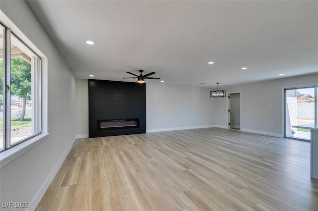 6100 Fawn Cir, Las Vegas, NV 89107 - unfurnished living room featuring light wood finished floors, recessed lighting, a fireplace, ceiling fan, and baseboards